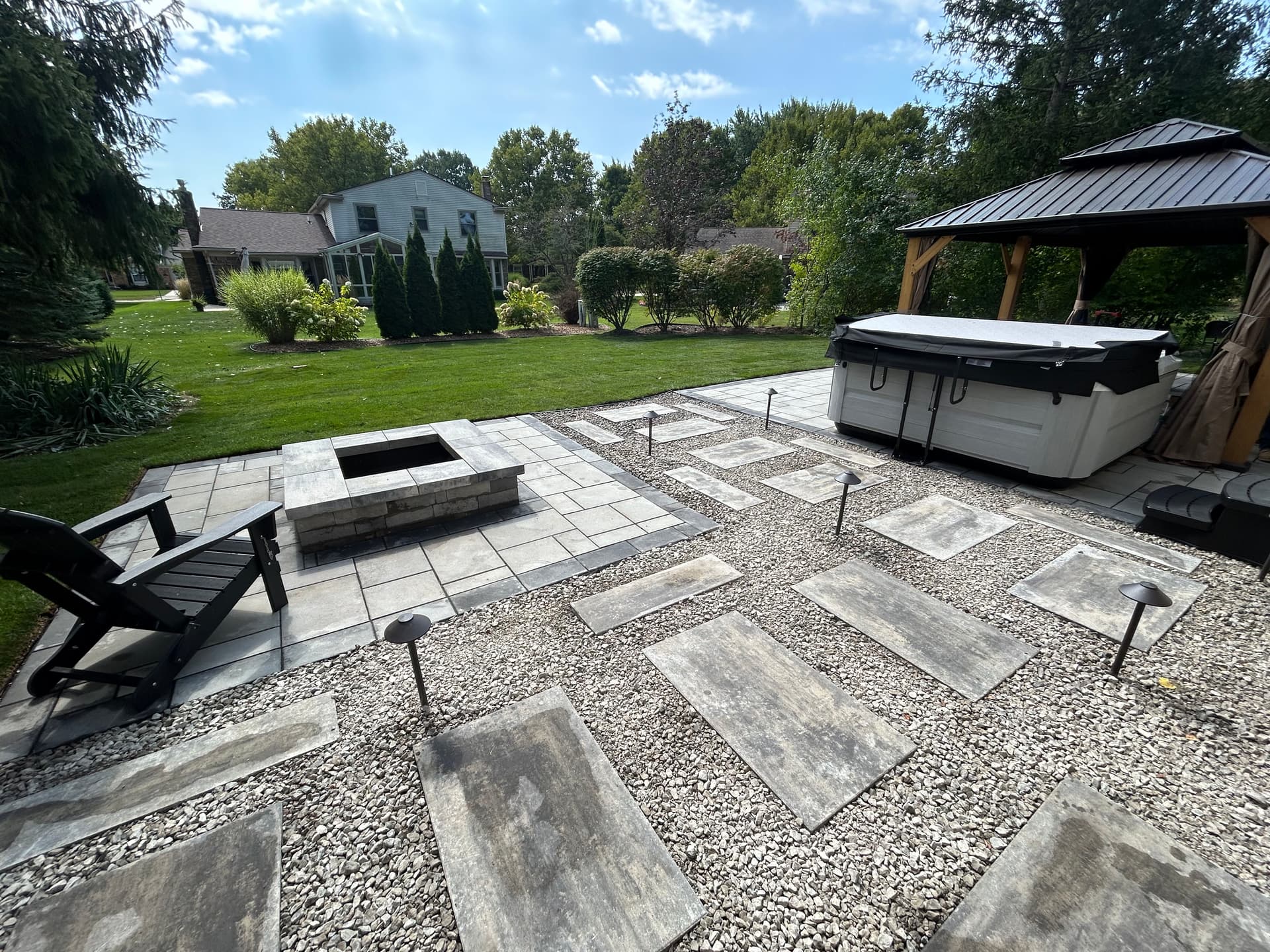 Backyard Oasis with Stunning Paver Patio and Fire Pit image