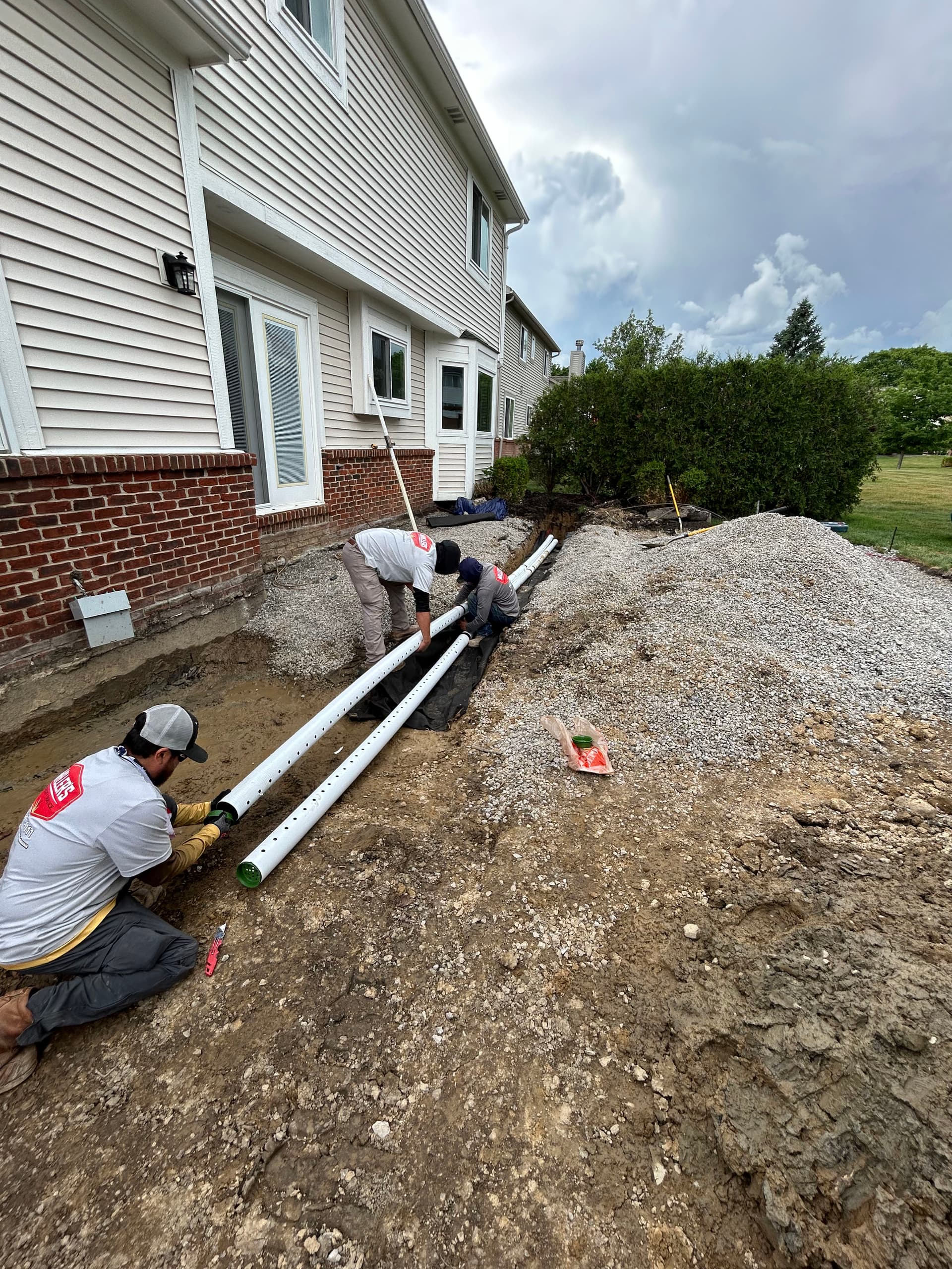 French Drain Installation Under a South Lyon Patio Build image